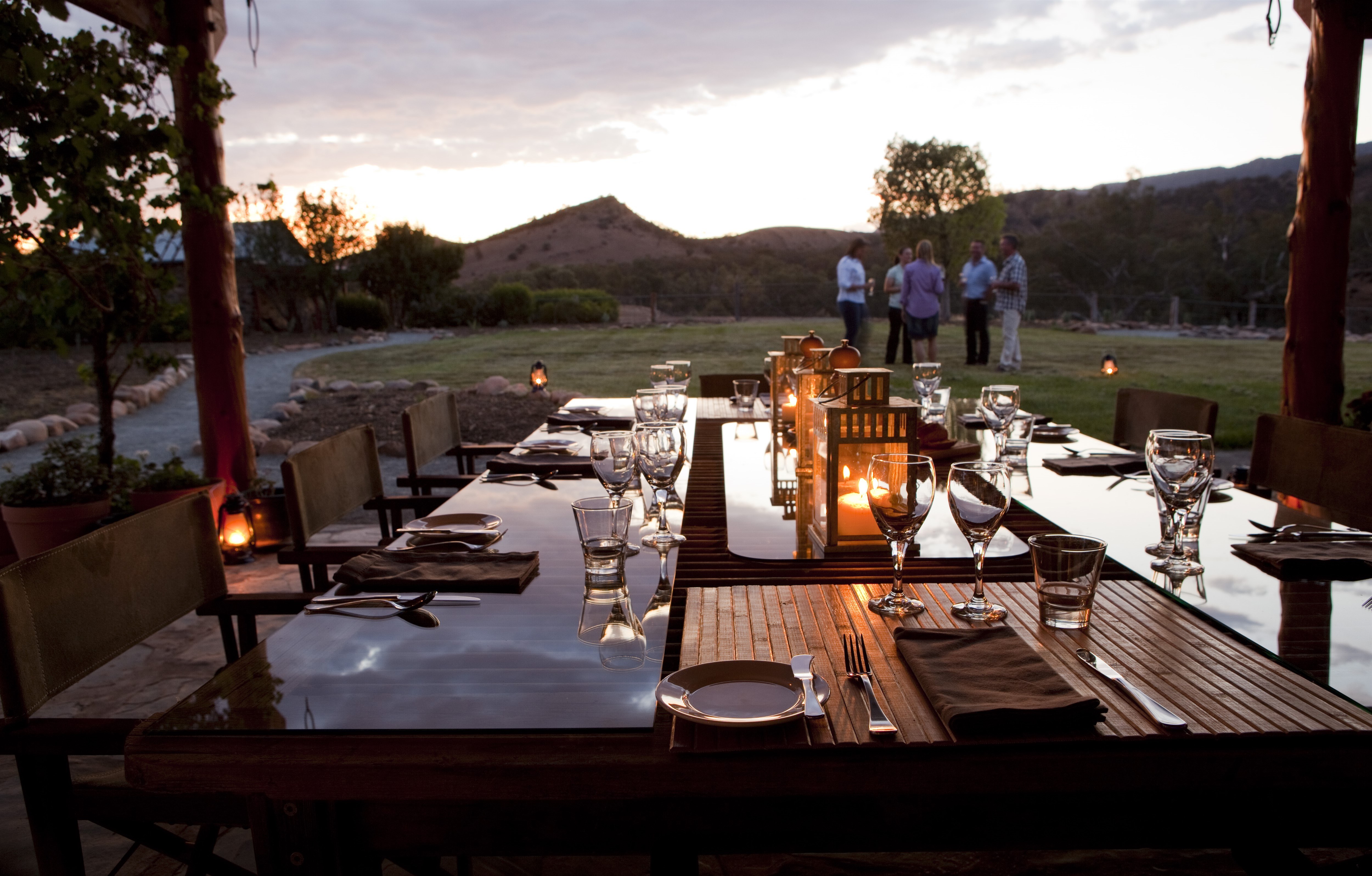 A dining room table set outside in the evening